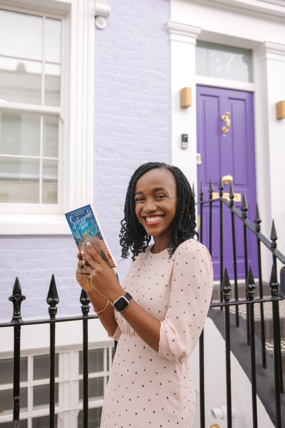 afoma umesi stands in notting hill reading saffiyah's war by hibar noor